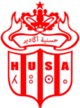 شعار النادي الجديد منذ 2013. الشعار عرف تغييرا طفيفا بإضافة الحروف الأمازيغية، لكون النادي ينتمي لإقليم سوس الأمازيغي في المغرب.