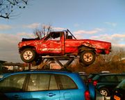 The heavily damaged, but still working, Top Gear Hilux perched on its plinth