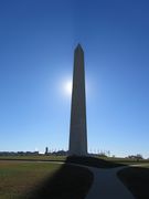 Washington Monument with the sun behind.