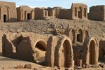 Ancient ruins with arches in a desert setting