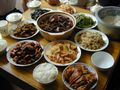 Chinese meal in Suzhou with rice, shrimp, eggplant, fermented tofu, vegetable stir-fry, vegetarian duck with meat and bamboo.