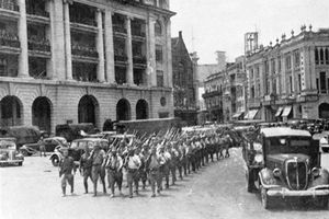 Army column marches through urban area