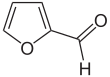 Skeleton formula of a ring of four carbons and one oxygen, with a carbon-oxygen attached to a carbon next to an oxygen