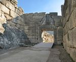 A gate of stone with a relief of two four legged animals.