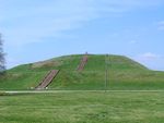 A large earthen mound with steps leading to the top