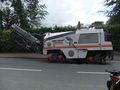 Folded conveyor on a tracked grinder