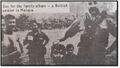 A British soldier poses with the decapitated head of a suspected pro-independence guerrilla