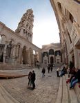 A grey palace building with columns.