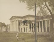 A colored-in photograph (1851) of Hindu College, Calcutta, which had been founded in 1817 by a committee headed by Raja Ram Mohun Roy. In 1855, the Government of the Bengal Presidency renamed it Presidency College and opened it to all students.