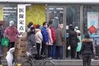 Citizens of Wuhan lining up outside of a drug store to buy masks during the Wuhan coronavirus outbreak.jpg