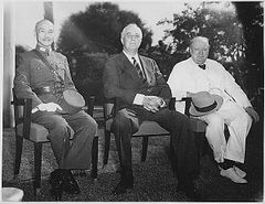 Three men, Chiang Kai-shek, Roosevelt and Churchill, sitting together elbow to elbow