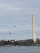 Marine One helicopter flies next to the monument, over the Tidal Basin.