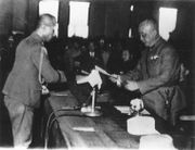 General Chen Yi of China accepts the surrender of Rikichi Andō, the Japanese Governor-General of Taiwan.