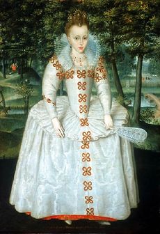 A full length portrait of a young girl wearing a large pale dress, with tight jewelled bodice, and long sleeves. She has brown hair, and wears a tiara. In her left hand she holds a fan. Behind her, a small river runs underneath a bridge, in a small glade filled with trees.