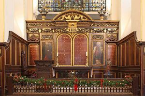 Church altar with four wooden panels, two of which show Moses and Aaron