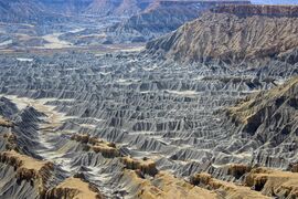 Badlands incised into shale at the foot of the North Caineville Plateau, Utah, within the pass carved by the Fremont River known as the Blue Gate