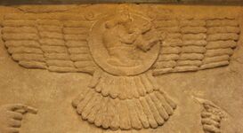 Male figure in an Assyrian winged sun emblem (Northwest Palace of Nimrud, 9th century BC).