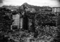 Scene of war damage in residential section of Seoul, Korea. The capitol building can be seen in the background (right). October 18, 1950. Sfc. Cecil Riley. (U.S. Army)