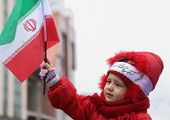 Child with the Islamic Republic flag during the 38th anniversary of the Iranian Revolution.