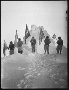 Photograph of the Robert Peary Sledge Party Posing with Flags at what was assumed to be the North Pole