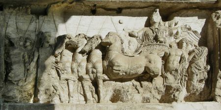Bas-relief of Roman driver in four-horse chariot, facing left