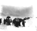Long trek southward: Seemingly endless file of Korean refugees slogs through snow outside of Kangnung, blocking withdrawal of ROK I Corps. January 8, 1951. Cpl. Walter Calmus. (U.S. Army)