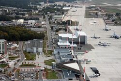 Aerial view of Ramstein showing hangars, warehouses and the passenger terminal alongside the flight line.