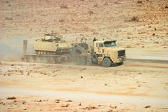 Oshkosh M1070A1 HET and DRS M1000 semi-trailer hauling an M2 Bradley IFV