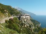 A large building complex and church built on a cliffside.