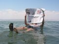 A tourist demonstrates the unusual buoyancy caused by high salinity