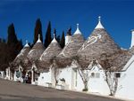 Small white houses with conic roofs.