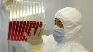 A scientist observing experimental SARS vaccine living in a culture medium.jpg
