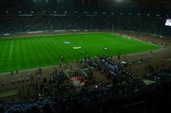 Flag bearers entering the pitch followed by both teams, Zamalek SC and Al-Zawra'a SC as well as a crowd of journalists and photographers, during the soft opening ceremony