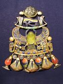 Pectoral (chest jewellery) of Tutankhamun; 1336–1327 BC (Reign of Tutankhamun); gold, silver and meteoric glass; height: 14.9 cm (5.9 in); Egyptian Museum (Cairo)