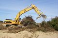 Normally the bucket is pulled toward the excavator to excavate material. The uncommon "thumb" attachment on this Caterpillar enables 'grabbing' objects, for example, during demolition.