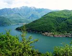 A wooded mountain and a lake.