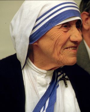 An image of Mother Teresa wearing a white head covering with blue stripes