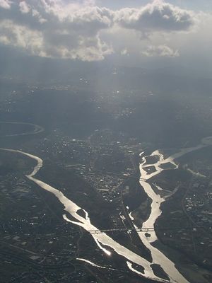 Aerial image showing two rivers meandering towards confluence near the bottom of the image.