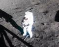 Armstrong on lunar surface with his gold visor raised. From 16 mm film (NASA).