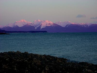 Sunset at Auke Bay, Alaska. Thanks to Rayleigh scattering, the mountains appear purple.