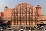 A large palace in red and pink sandstone with many windows