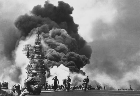 American aircraft carrier يوإس‌إس Bunker Hill burns after being hit by two kamikaze planes within 30 seconds.