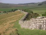 A very long wall separating two large plains.