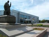 The Akan Sery monument with Palace of Culture and Akmola Regional Russian Drama Theater behind it