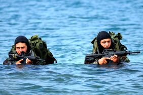 US Navy Basic Underwater Demolition-SEAL (BUD-S) students wade ashore on an Island during an exercise