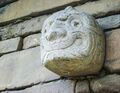 Tenon head embedded in one of the walls of the temple of Chavín de Huantar.