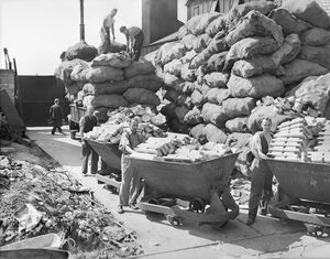 Bagged aluminium supplies piled up before carts of aluminium metal