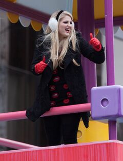 Meghan Trainor in a lip-patterned top, black coat and pants in New York City