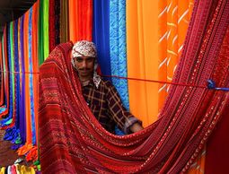 Traditional Sunday textile market on the sidewalks of Karachi, Pakistan.
