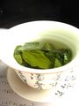 Oolong tea leaves steeping in a gaiwan.
